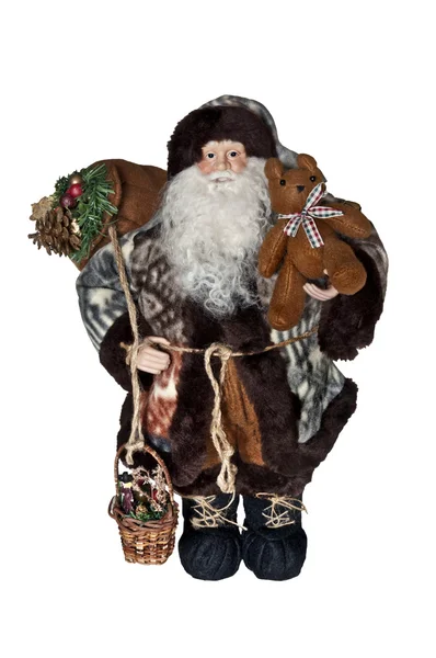 Santa Claus in natuurlijke outdoor kleding dragende zak en teddy bear. — Stockfoto