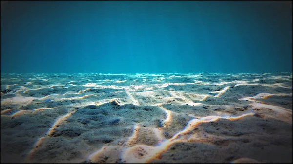 Artistic underwater photo of sand bottom in magic sunlight. From a scuba dive in the Atlantic ocean - Canary islands - Spain.