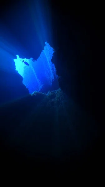 Beautiful and amazing rays of light in underwater cave. Underwater photo from a scuba dive in Canary islands in the Atlantic ocean.