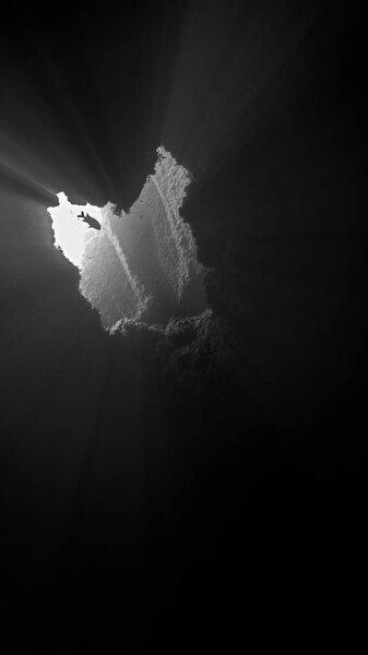 Красивые и удивительные лучи света в подводной пещере. Подводное фото с акваланга на Канарских островах в Атлантическом океане.