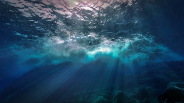Beautiful and amazing underwater photo of waves in rays of light. From a scuba dive in Canary islands in the Atlantic ocean. clipart