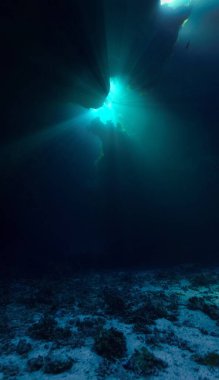 Cathedrals of light - Underwater photo of rays of sunlight inside caves. and tunnels From scuba cave diving in the south of Egypt. St:Johns reef.