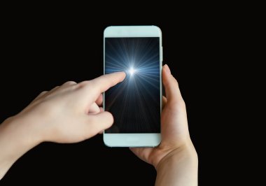 Kadının işaret parmağı, bir akıllı telefonun mavi ekranını işaret ediyor. Siyah arka planda bir cep telefonu. Parmağını yakın plandaki telefon ekranına doğrult. Sanal gerçeklik. Çevrimiçi iletişim