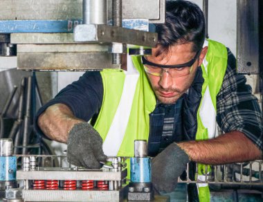 Profesyonel bir erkek mühendisin portresi güvenlik üniforması ve gözlük takıyor. Makinelerin bakımı ve kurulumu Endüstriyel fabrikalarda Metal parçaları üreten mühendislik işi kavramı