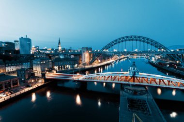 Newcastle on Tyne UK: 30 Mart 2021: Newcastle Gateshead Quayside, with Tyne Bridge and city skyline, long posure during blue hour