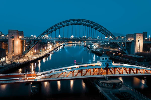 Newcastle on Tyne UK: 30 Mart 2021: Newcastle Gateshead Quayside, with Tyne Bridge and city skyline, long posure during blue hour