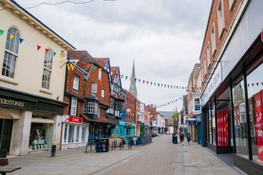 Salisbury UK: 27 Temmuz 2025: Salisbury ana caddesi Pazar sabahı boş. Sokaklar büyüleyici dükkanlar ve geleneksel binalarla dolu.