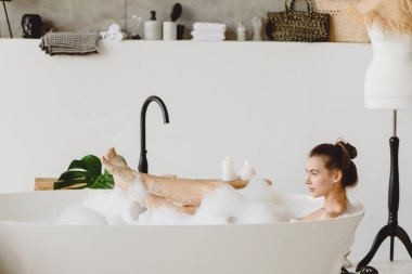 Beautiful woman in a bubble bath. clipart