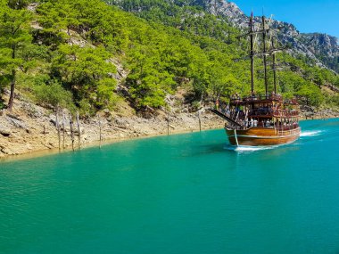 Güneşli, bulutsuz bir günde, dağların arka planına karşı deniz manzarası.