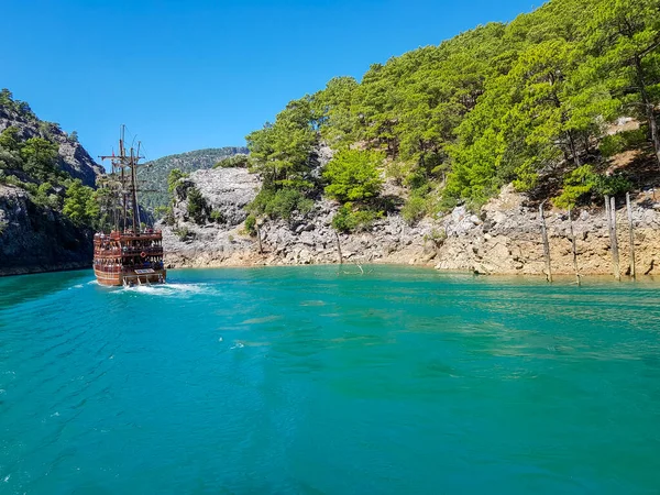 Güneşli, bulutsuz bir günde, dağların arka planına karşı deniz manzarası.