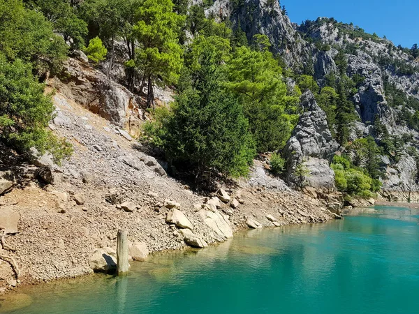 Güneşli, bulutsuz bir günde, dağların arka planına karşı deniz manzarası.