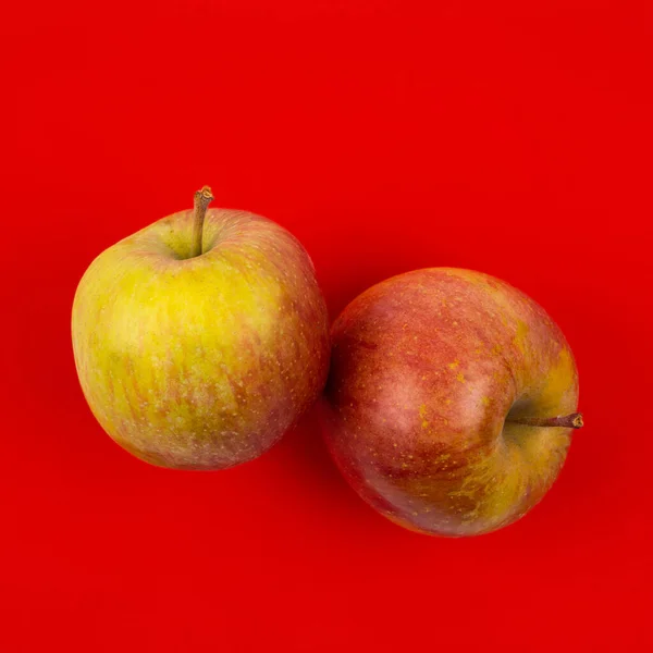 Fresh red apple on red background. — Stock Photo, Image