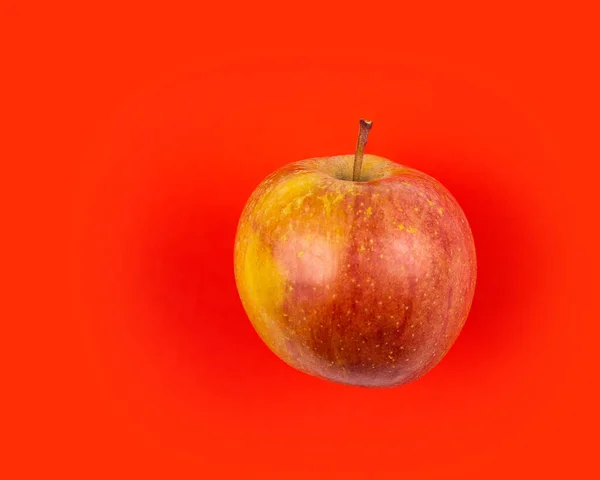 Fresh red apple on red background. — Stock Photo, Image