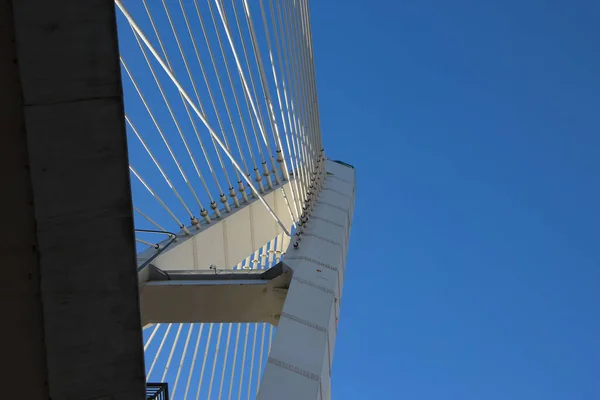Close-up of a cable-stayed bridge pylon in the place where the cables are fastened, view from under the bridge