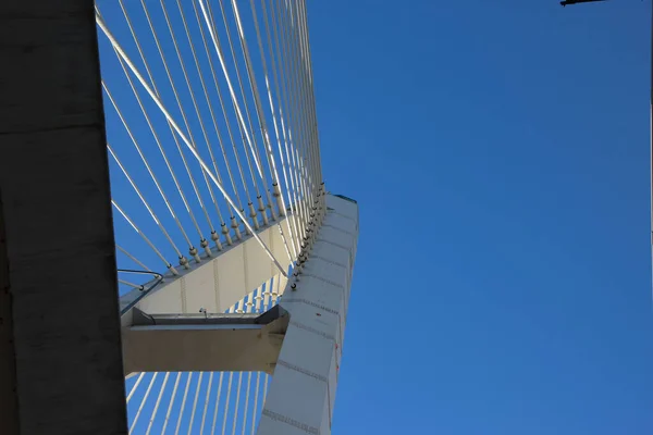 Close-up of a cable-stayed bridge pylon in the place where the cables are fastened, view from under the bridge