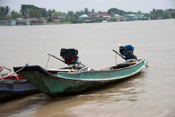 Two wooden boat machine landing on the water in the river. it is a small vessel propelled on water by an engine