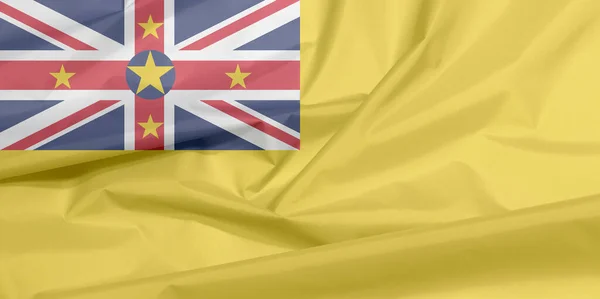 Stofvlag Van Niue Vouw Van Niue Vlag Achtergrond Een Gouden — Stockfoto