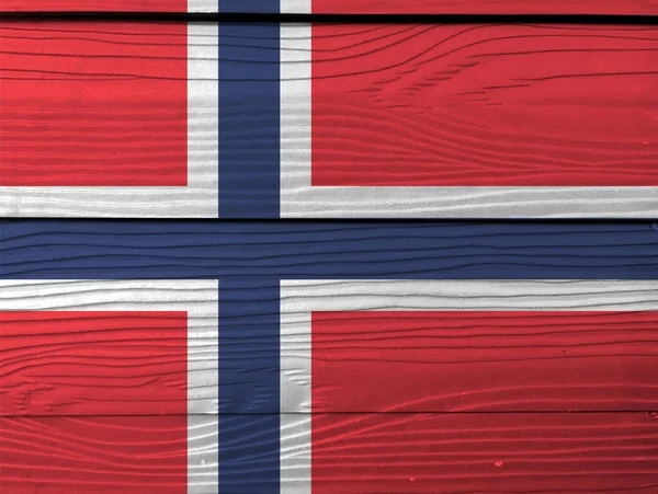 Flag of Norway on wooden wall background. Grunge Norwegian flag texture, a white-fimbriated blue Nordic cross on a red field.