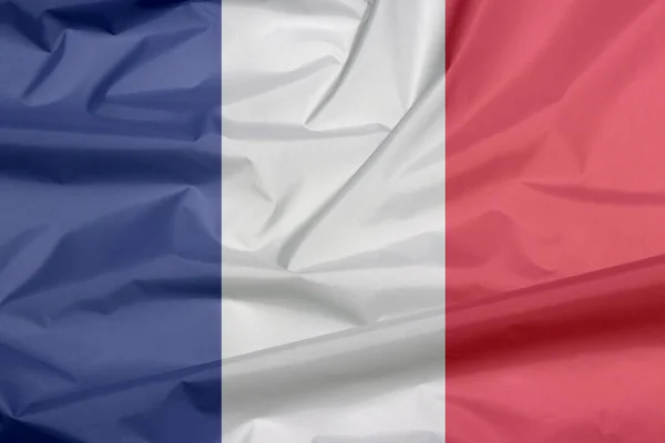 Fabric flag of France. Crease of French flag background, it is a vertical tricolor of blue white and red.