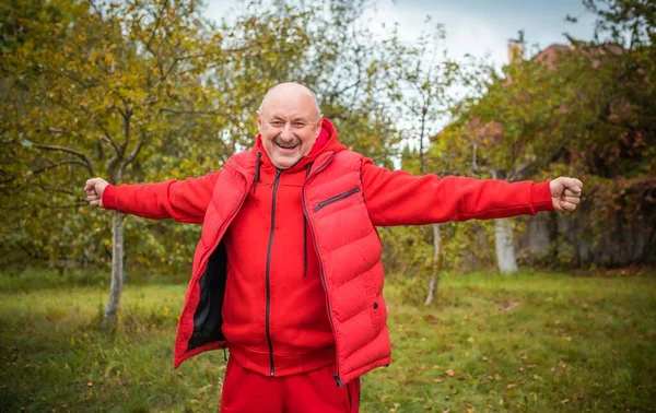 Senior man in red sportswear, man retired, lifestyle of older people