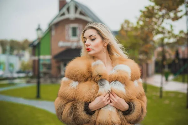 Gorgeous plus size blonde European woman in luxury fur coat, women\'s beauty. Concept of furs