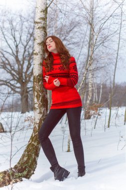 Tatil günleri, Noel kış zamanı. Tatilde olan bir kadın dışarıda yürüyor. Sıcak giyimli bir kız, kadın modası konsepti. Oldukça hoş bir tarz.