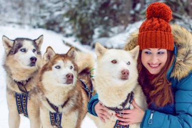 Kış ve Noel 'le ilgili bir şey. Kış, hayallerin gerçekleşmesi için büyülü bir zamandır. Karlı kış manzarasında güzel bir kadın portresi. Güzel bir kadınla Sibiryalı Husky Dog 'un sihirli anları kutlu olsun.