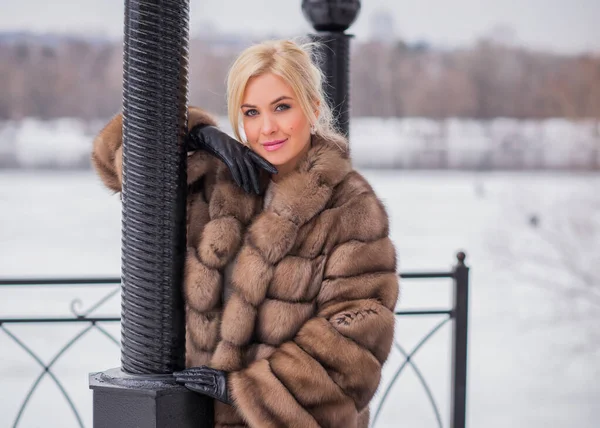 Nice elegant lady in fur coat at nature, autumn - winter season time, woman with attractive appearance