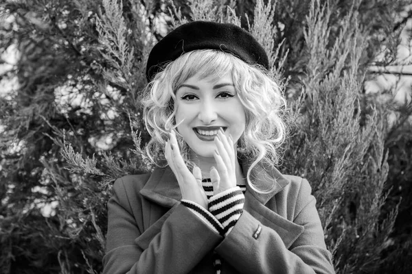 Happy French woman. Portrait of young blonde woman in beret smiling in French vintage style. Retro stylization. French style.