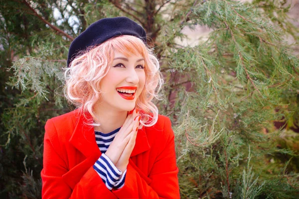 Happy French woman. Portrait of young blonde woman in beret smiling in French vintage style. Retro stylization. French style.