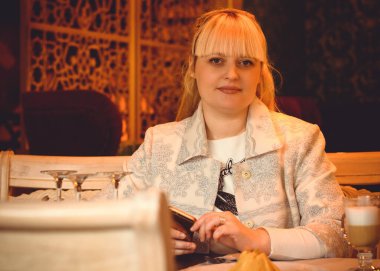 Orta yaşlı iş kadını kafede çalışıyor ve oturuyor. Şehir merkezindeki kadınlar XI beden ya da beden ölçüsünde işçiler.