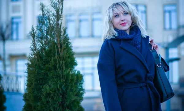 Concept of life modern woman in big city, lifestyle citizen peoples, lady at spring or autumn day. Middle age woman in coat and scarf walk around center streets