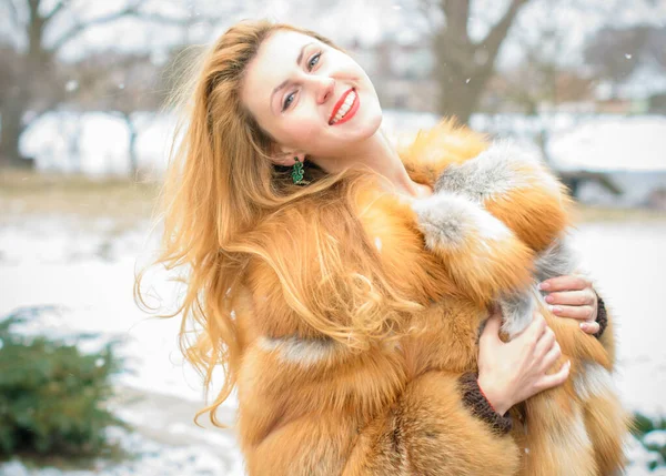 Stylish lady in a vintage style of clothes. She is dressed in a velvet dress and a light red fur coat. Style 50s in modern life