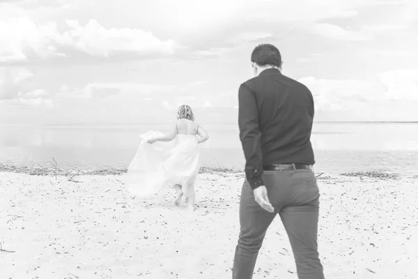 Blond bride and groom on wedding. Happy wedding couple. Beautiful bride, young woman in white dress groom kissing and having fun in outdoor on summer day. Just married, young family.