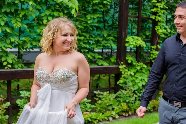 Blond bride and groom on wedding. Happy wedding couple. Beautiful bride, young woman in white dress groom kissing and having fun in outdoor on summer day. Just married, young family.