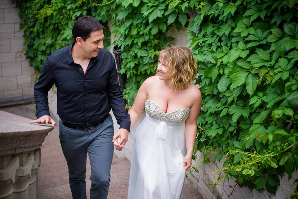 Blond bride and groom on wedding. Happy wedding couple. Beautiful bride, young woman in white dress groom kissing and having fun in outdoor on summer day. Just married, young family.