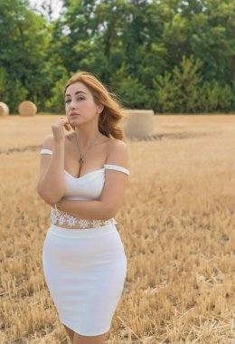 Doğuştan modern, dolgun kalçalı, beyaz kostümlü güzel bir kadın. Kadınlık kavramı