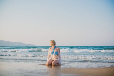 Tatillerde güzel bir kadın, plaj manzaralı bir yer, sahil, deniz. Tatiller ve macera konsepti