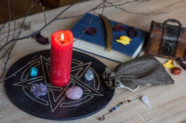 Altar with a pentagram to attract love, happiness, candle, stones, Tarot cards and witchcraft at home