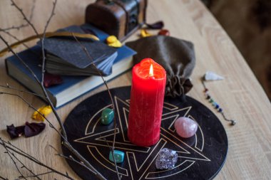 Altar with a pentagram to attract love, happiness, candle, stones, Tarot cards and witchcraft at home