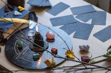 Altar with a pentagram to attract love, happiness, candle, stones, Tarot cards and witchcraft at home