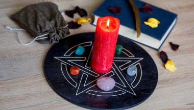 Altar with a pentagram to attract love, happiness, candle, stones, Tarot cards and witchcraft at home
