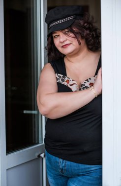 Orta yaşlı ve hayattan zevk alan iri yarı bir kadın. Aşırı kilolu, şık giyinmiş olgun bir bayan. Doğal güzellik.