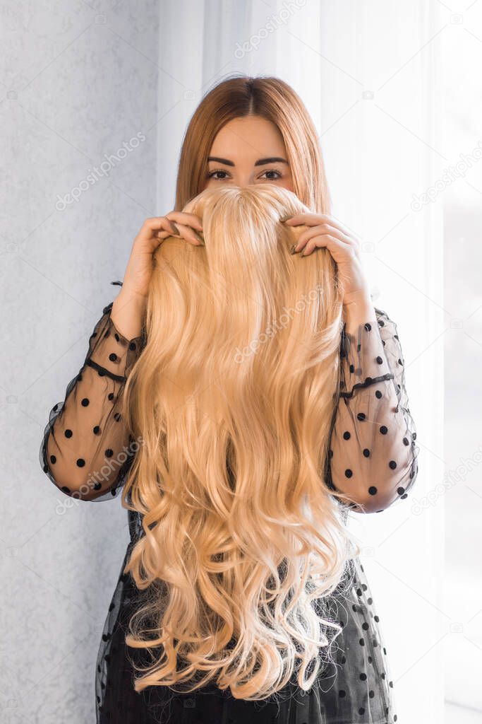 Wigs synthetic and natural hair. Women`s beauty concept