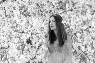 Bahar çiçekleri bahçesinde romantik bir kadın. Kadın kavramı ve şefkat, modern güzellik veya kadınlık.