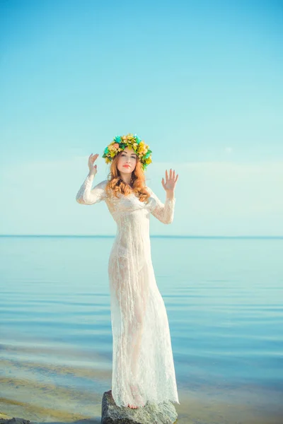 Woman in lace white dress in the water. Art Woman with wreath on her head in river. Wet witch Girl in the lake, mystical mysterious woman. Wreath on her head, Slavic traditions and paganism