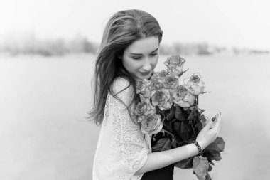 Bahar büyüsü, açık havada bir buket çiçekli romantik kadın.