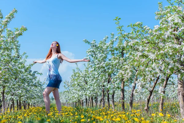 Bahar çiçekleri bahçesinde romantik bir kadın. Kadın kavramı ve şefkat, modern güzellik veya kadınlık.