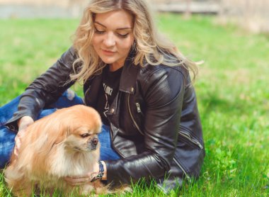 Güzel, sarışın bir kadın. Sokakta köpeği, doğal güzelliği, modern bir bayanı var. Ben veya XI beden, artı beden modeli.