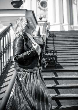 Young stylish woman walking on the city street at spring . Casual fashion modern look. Plus size model. Happy overweight woman walking the city streets